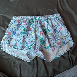 A pair of athletic shorts. They are baby blue with the flower design.